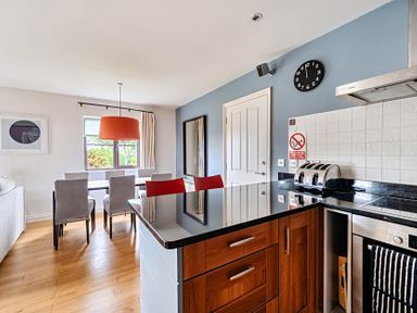A kitchen with a dining area at 2bed sleeps4 pool freeparking Trenythonestate Near Par
