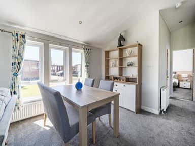 A dining room with a table and chairs at Atlantic Breeze Luxury Lodge sleep 6 Mullacott near Ilfracombe