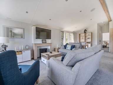 A living room with a sofa and television at Atlantic Breeze Luxury Lodge sleep 6 Mullacott near Ilfracombe