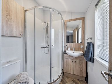 A bathroom with shower, sink, and toilet at Atlantic Breeze Luxury Lodge sleep 6 Mullacott near Ilfracombe
