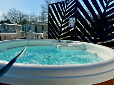 A hot tub on a deck surrounded by a fence at Meadows 33 Hot tub Southview Holiday Park Skegness
