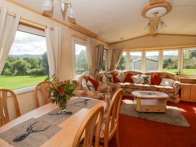 A snug with a sofa and dining table at Leven in Lampeter