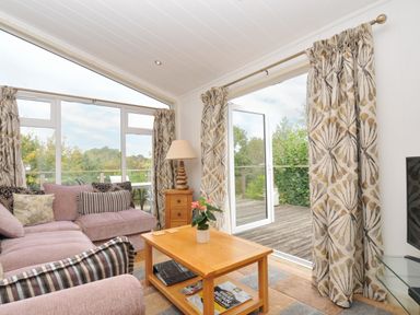 A living room with a sofa and coffee table at 5 Tree Tops in Dobwalls