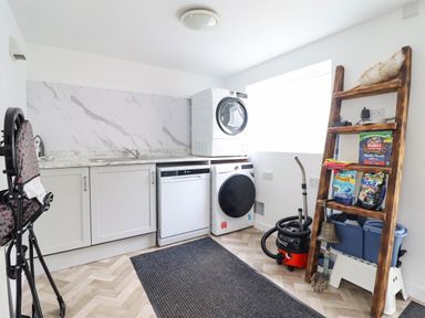 A laundry room with appliances and storage at 1 Glanaber Terrace