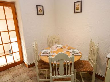 A dining room with a table and chairs at The Stable in Haverfordwest