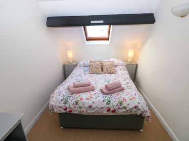 A bedroom with a bed and bedside tables at The Stable in Haverfordwest