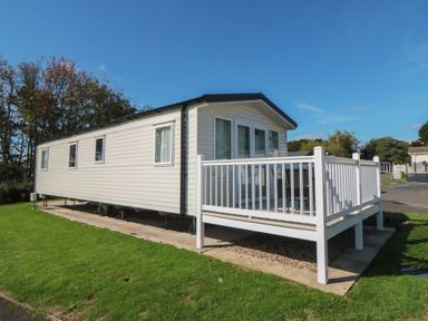 A mobile home with a deck at 14 Pines in Cayton Bay