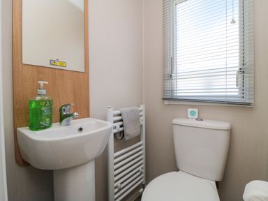 A bathroom with a sink and toilet at 14 Pines in Cayton Bay