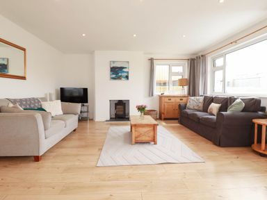 A living room with a sofa and a coffee table at Cloudbreak in Wadebridge