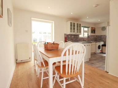 A dining room with a table and chairs at Cloudbreak in Wadebridge