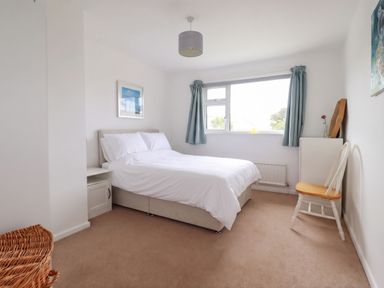A bedroom with a bed and side table at Cloudbreak in Wadebridge
