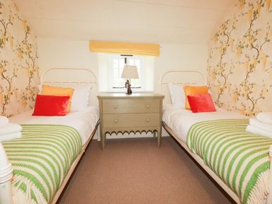 A bedroom with two beds and a nightstand at The Homestead