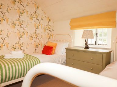 A bedroom with two beds and a dresser at The Homestead in 