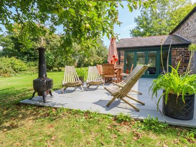 An outdoor seating area with chairs and table at The Homestead in 