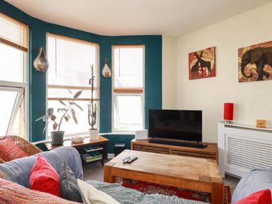 A living room with a couch and television at Seaside Retreat in Newquay