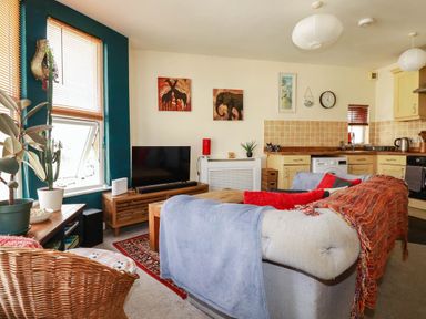 A living room with a sofa and television at Seaside Retreat in Newquay