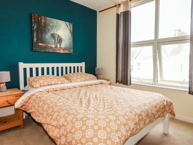 A bedroom with a bed and bedside tables at Seaside Retreat in Newquay