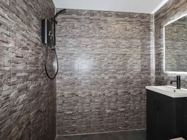 A bathroom with a shower and sink at The Hyde, Tazamble cottage Launceston