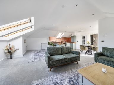 A living room with a sofa and dining area at Apartment Sleeps 4 with Balcony and Parking in Kingsbridge