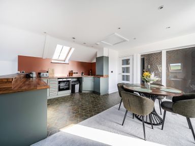 A kitchen with a dining table and chairs at Apartment Sleeps 4 with Balcony and Parking in Kingsbridge