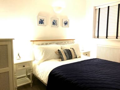 A bedroom with a bed and bedside table at Torpoint Apartment Sleeps4 Seaside Parking in Downderry