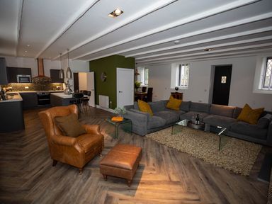 A living room with a sofa and armchair at Stunning 3 Bed Converted Village Hall Near Kelso Nenthorn near Kelso