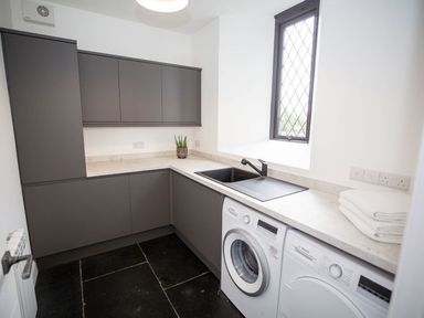 A utility room with a washing machine and sink at Stunning 3 Bed Converted Village Hall Near Kelso Nenthorn near Kelso