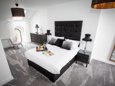 A bedroom with a bed and a window at Stunning 3 Bed Converted Village Hall Near Kelso Nenthorn near Kelso