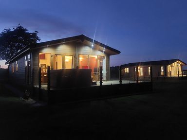 A lodge with deck lights near Lochwinnoch