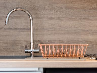 A sink with a faucet and a copper drain rack at 2 bedroom lodge with free WiFi and mountain view near Crianlarich