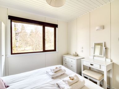 A bedroom with a bed and a window at a 2 bedroom lodge with free WiFi and mountain view near Crianlarich