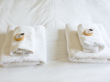Two stacks of towels with soap on a bed at 2 bedroom lodge with free WiFi and mountain view near Crianlarich