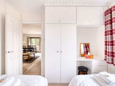 A bedroom with a wardrobe and mirror at 2 bedroom lodge with free WiFi and mountain view near Crianlarich