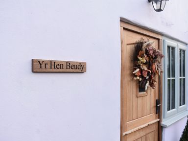A door with a sign and wreath at Yr Hen Beudy Barn Conversion Sleeps 4 Dogs Ok, Broadle Farm near Llansteffan