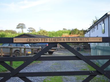 A gate with a sign at Yr Hen Beudy Barn Conversion Sleeps 4 Dogs Ok near Brodle Farm near Llansteffan