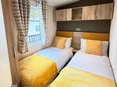 A bedroom with two beds and window at Lillardsedge Luxury Caravan Sleeps 6 with Parking near Lilliardsedge Holiday Park