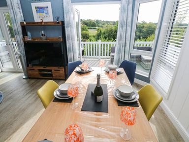 A dining room with a table set for a meal at Pleasant Valley Holiday Lodge 70 Stepaside