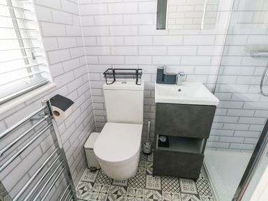 A bathroom with a toilet and sink at Pleasant Valley Holiday Lodge 70 Stepaside