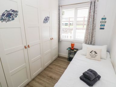 A bedroom with a bed and wardrobe at Pleasant Valley Holiday Lodge 70, Stepaside