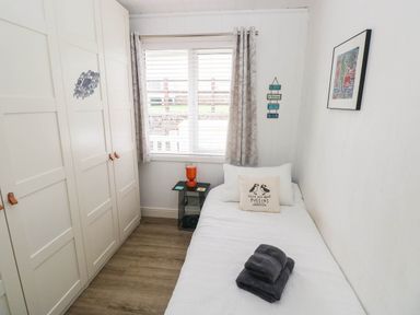 A bedroom with a bed and wardrobe at Pleasant Valley Holiday Lodge 70 Stepaside