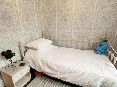 A bedroom with a bed and nightstand at 11 Bryn Goleu Avenue North in Holyhead