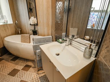 A bathroom with a bathtub and vanity sink at 11 Bryn Goleu Avenue North in Holyhead