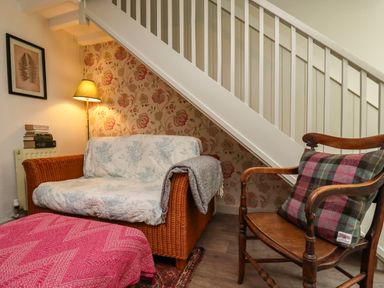 A snug with a sofa and armchair at Blue Cottage in Malton