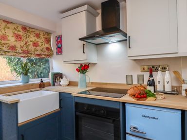 A kitchen with a sink, oven, and stove at Blue Cottage in Malton