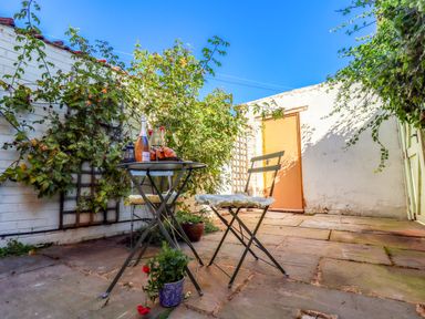 A garden with a table and chairs at Blue Cottage in Malton