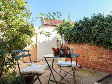 A garden with a table and chairs at Blue Cottage in Malton