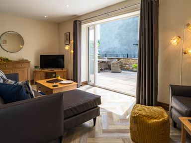 A living room with a television and coffee table at Bay Bungalow 