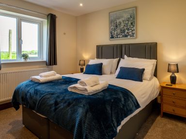 A bedroom with a bed and window at Bay Bungalow