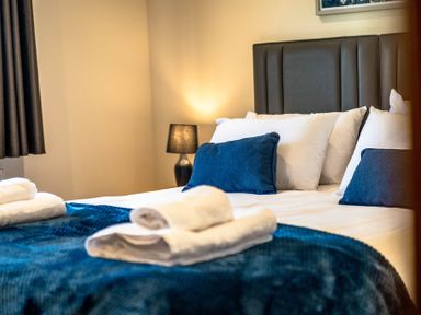 A bedroom with a bed and pillows at Bay Bungalow