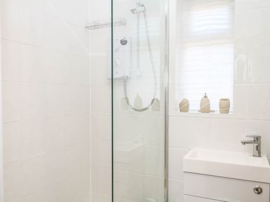 A bathroom with a shower and sink at Elberry Cove View in Paignton